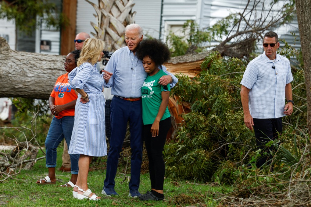 US President Joe Biden and first lady Jill Biden speak with a woman during their tour of Hurricane Idalia storm destruction in Live Oak, Florida, on Saturday. Photo: Reuters
