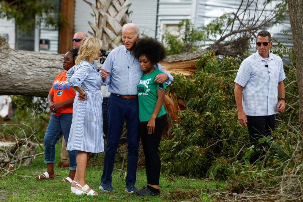 US President Joe Biden and first lady Jill Biden speak with a woman during their tour of Hurricane Idalia storm destruction in Live Oak, Florida, on Saturday. Photo: Reuters