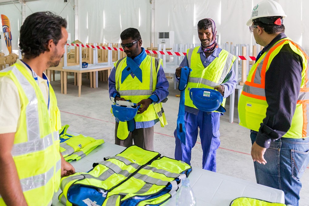 Workers in Qatar who built stadiums for last year’s World Cup try out cooling vests in 2018. As climate change causes temperatures to soar, start-ups around the world are developing clothing that beats the heat in innovative ways. Photo: AFP