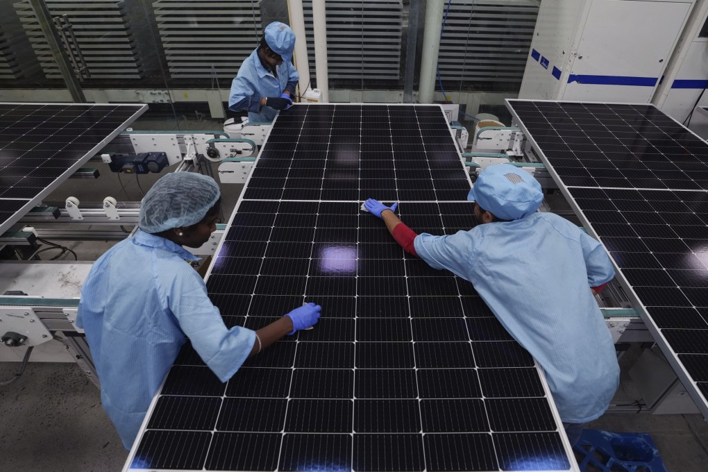 Machine operators clean solar panels at Premier Energies Solar on the outskirts of Hyderabad, India, on January 25. The recent trend of countries and firms trying to diversify their supply chains has been music to the ears of India, which has set itself ambitious targets for increasing manufacturing’s share of the country’s GDP. Photo: AP