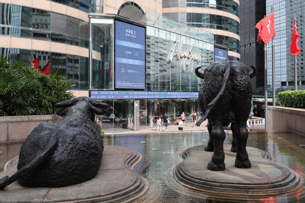Statues of bulls face an electronic billboard displaying the Hang Seng Index and stock prices outside the Exchange Square in Central on June 30. Photo: Yik Yeung-man