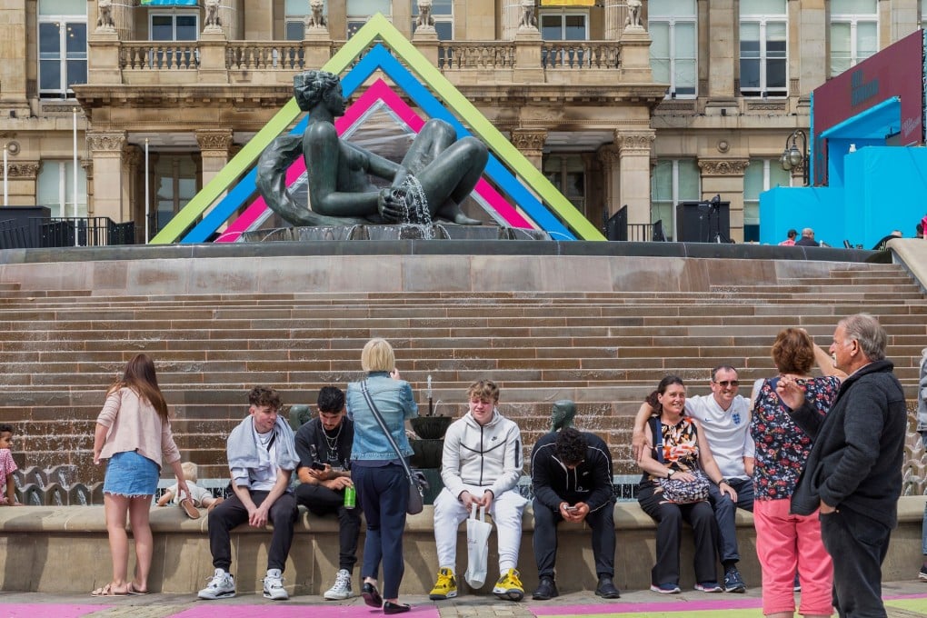 Visitors sit in front of The Floozie in the Jacuzzi and the Birmingham City Council House. Birmingham confirmed on Tuesday that the city is in financial distress. Photo: Shutterstock Images