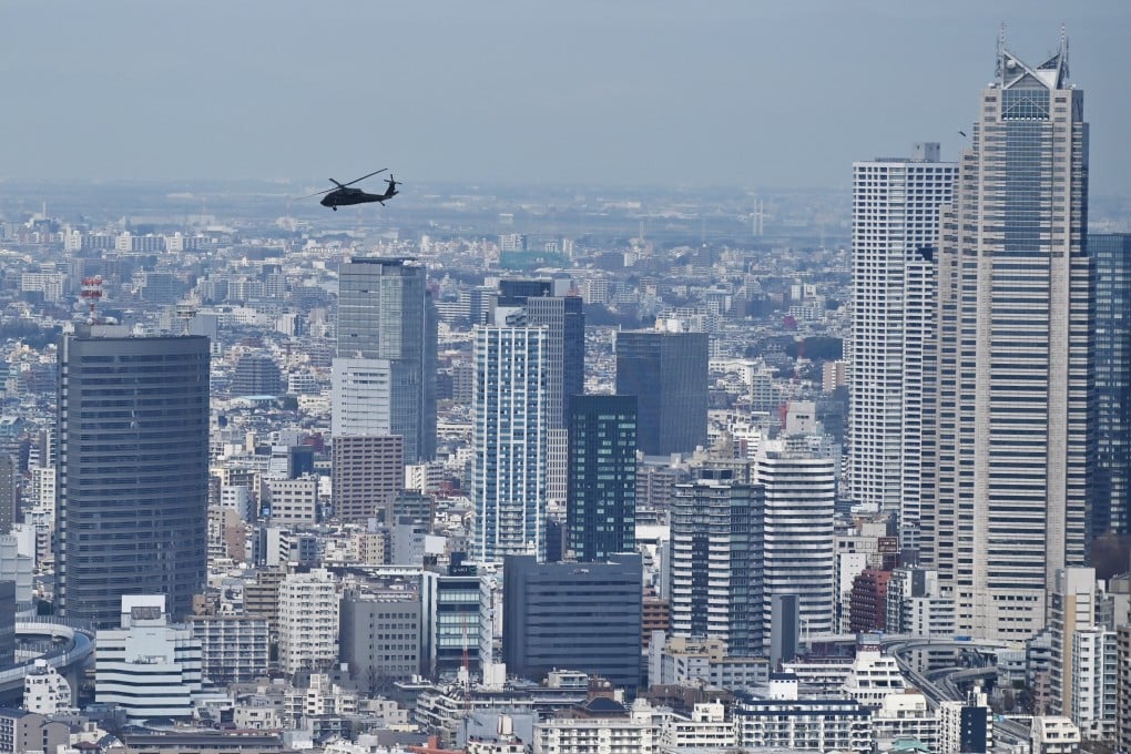 A military helicopter flies over Tokyo in 2020. The completion of new tower blocks in the Japanese capital will further restrict air access to the Hardy Barracks heliport that’s used by the US. Photo: AFP