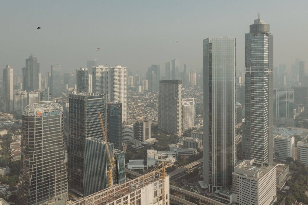 Buildings seen shrouded in smog in Jakarta last month. Indonesia has pledged to stop building new coal-fired power plants from 2023 and to be carbon neutral by 2050. Photo: Bloomberg