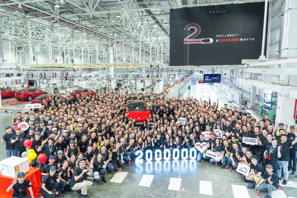Tesla employees at its Gigafactory 3 in Shanghai with its two-millionth vehicle to roll off the production line. Photo: Handout