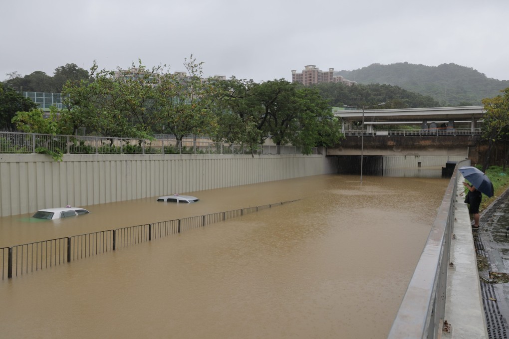 A road in Tai Po becomes a river as floodwater submerges stranded vehicles. Photo: Jelly Tse