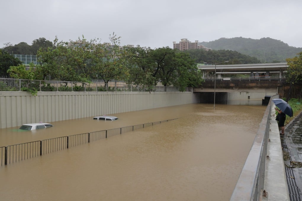 A road in Tai Po becomes a river as floodwater submerges stranded vehicles. Photo: Jelly Tse