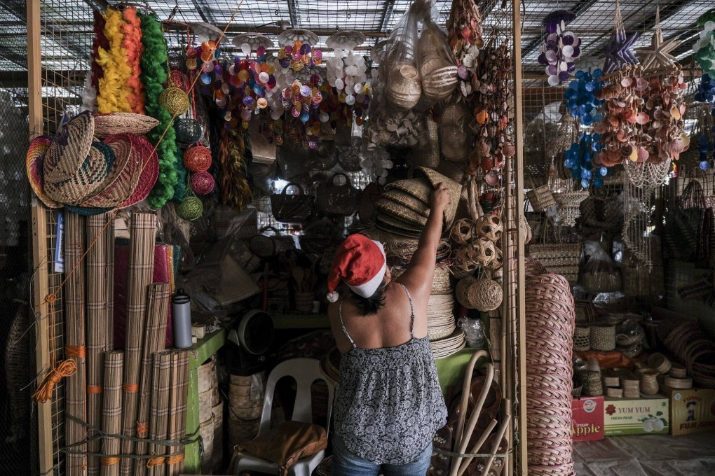 A vendor arranges goods in a souvenir stall in Cebu City, the Philippines, on Friday. Photo: Bloomberg