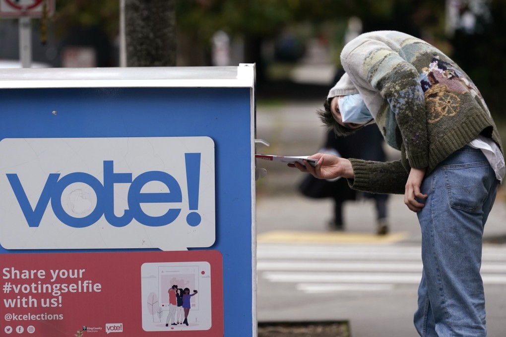 A voter places his ballot in a drop box in Seattle, Washington, in October 2020. Photo: AP