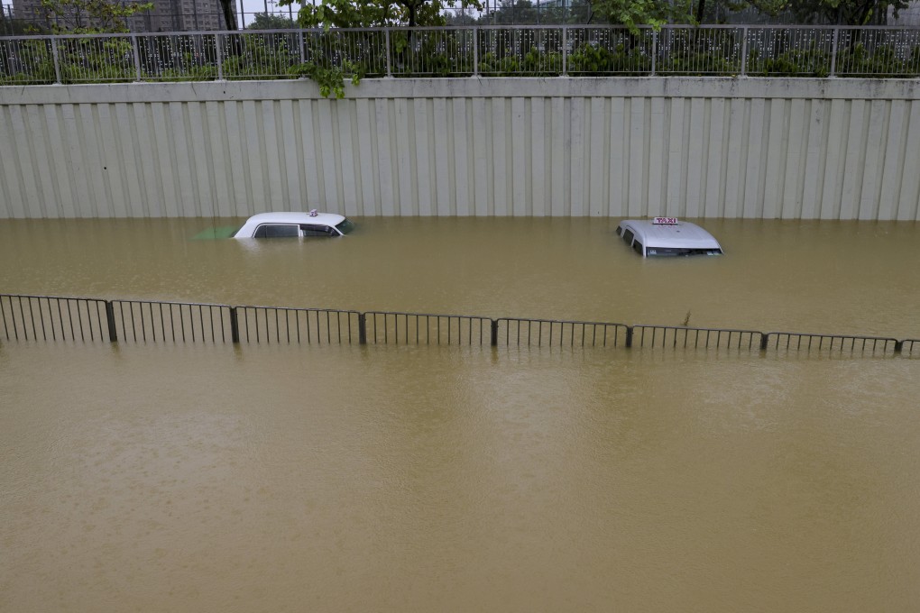 Submerged cabs in a flooded street in Hong Kong’s Tai Po district on Friday. Photo: Jelly Tse