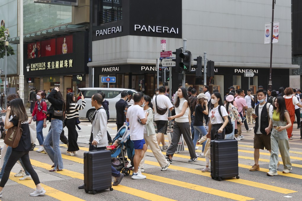 Shoppers with suitcases cross Canton Road in Tsim Sha Tsui, Hong Kong, on May 13, 2023.
Photo: Yik Yeung-man