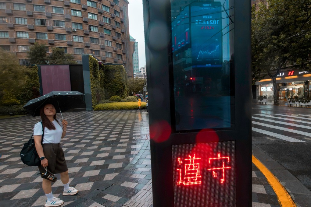 Stock-exchange data is reflected in a traffic light stand in Shanghai. The Shanghai Composite has risen 2.4 per cent since the CSRC’s announcement about curbing stock supply. The gauge, however, trails other key markets in Asia such as Japan and South Korea. Photo: EPA-EFE