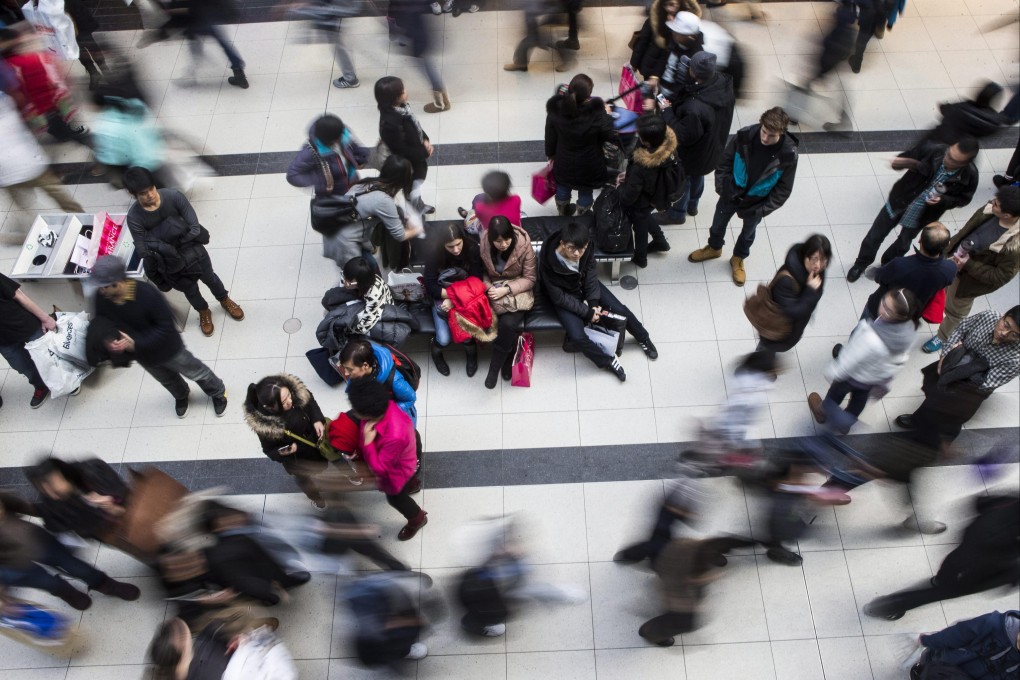 Shoppers make their way through the Eaton Centre as they visit the Boxing Day sales in Toronto on December 26, 2013. Photo: AP