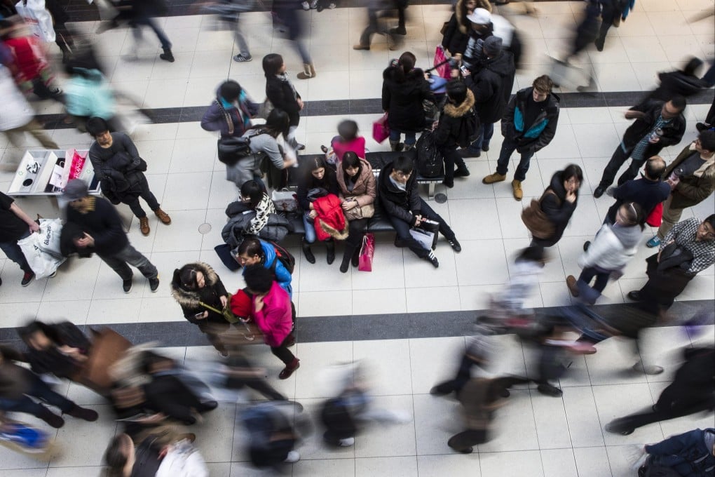 Shoppers make their way through the Eaton Centre as they visit the Boxing Day sales in Toronto on December 26, 2013. Photo: AP