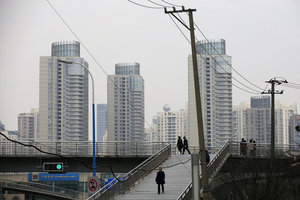 People seen on a bridge near the district of Pudong in Shanghai. Photo: Reuters