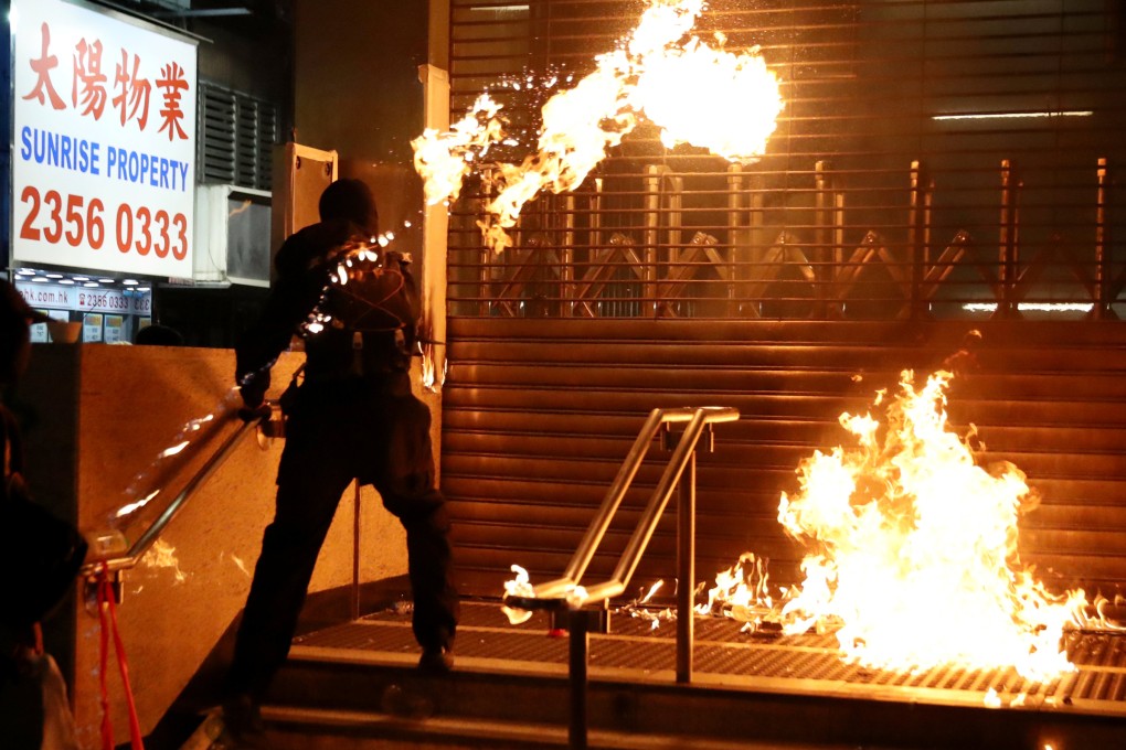 A protester throws a Molotov cocktail at an MTR station in Hung Hom after a day of protests in Hong Kong in 2019. Photo: Reuters