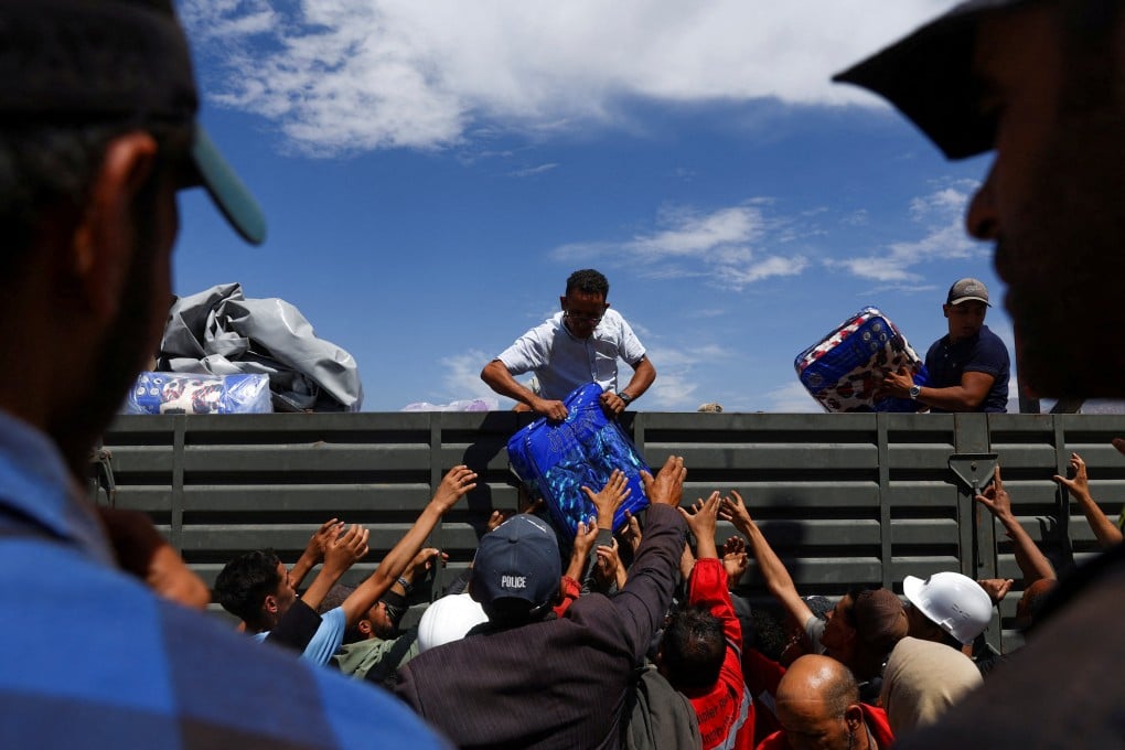People receiving aid in the aftermath of a deadly earthquake, in Talat N’Yaaqoub, Morocco. Photo: Reuters