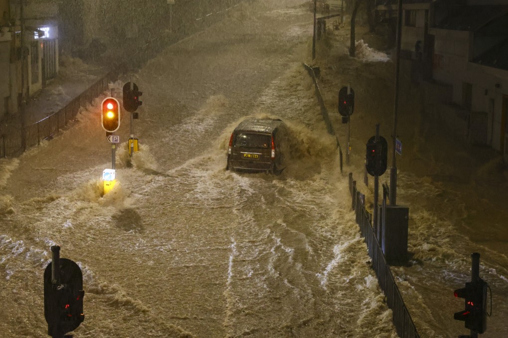 A car is engulfed by floodwaters in Hong Kong’s Chai Wan district on September 8 as the city experiences its heaviest rainfall since records began. Photo: Dickson Lee