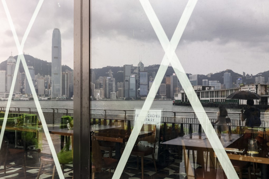 Hong Kong Island is reflected in taped windows in Tsim Sha Tsui as super typhoon Saola hit the city on September 1, 2023. Photo: Yik Yeung-man