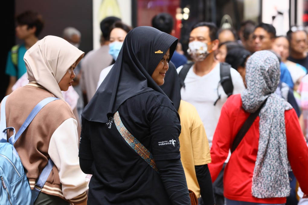 Indonesian women wearing headscarves walk near Victoria Park in Causeway Bay. Photo: Dickson Lee