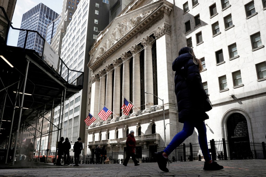 People are seen on Wall Street outside the New York Stock Exchange in New York City in March 2021. The Financial Stability Board has warned of “further challenges and shocks” in coming months as high interest rates undermine economic recovery and threaten key sectors, including real estate. Photo: Reuters