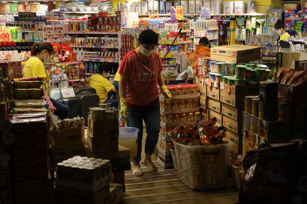 Store employees clear up last week after record rainfall caused flooding in parts of Hong Kong. Photo: Yik Yeung-man