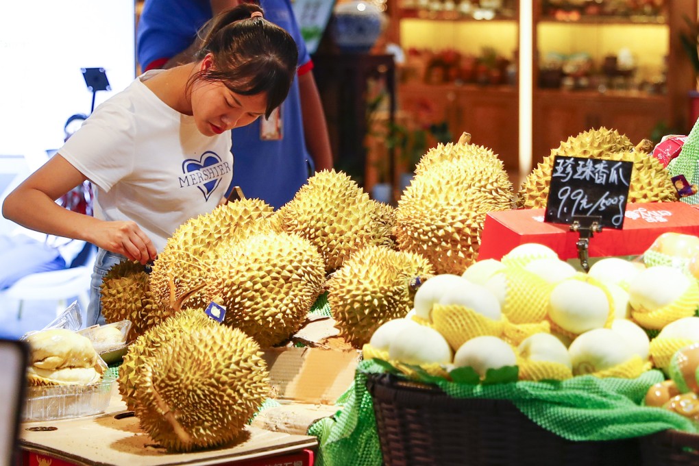 A shopper chooses among imported durian at a supermarket in Nanning, in southern Guangxi Zhuang Autonomous Region, on September 7. The notoriously odorous fruit has rapidly gained popularity among China’s middle-class consumers, creating a surge in imports and another avenue through which China and Vietnam are closely linked. Photo: Xinhua