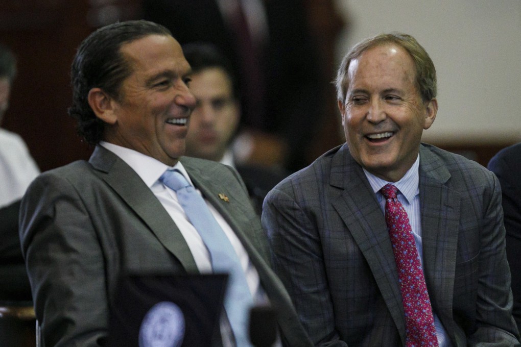 Texas Attorney General Ken Paxton (centre) sits with defence lawyer Tony Buzbee (left) at his impeachment trial in Austin on Friday. Photo: The San Antonio Express-News via AP