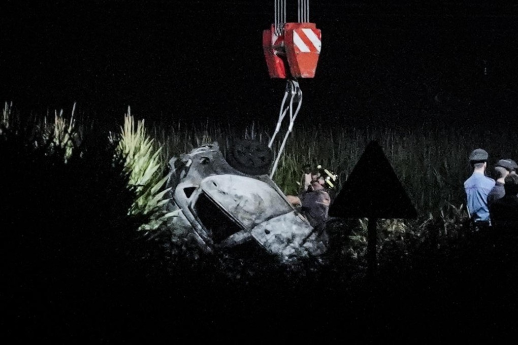 Rescuers remove the wreckage of a car at the site of a plane crash near the airport of Caselle, Turin, northern Italy. Photo: EPA-EFE