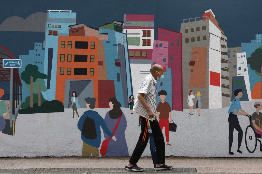 A man passes a colourful mural outside Mong Kok Police Station in Hong Kong on October 10, 2021. Photo: Jonathan Wong