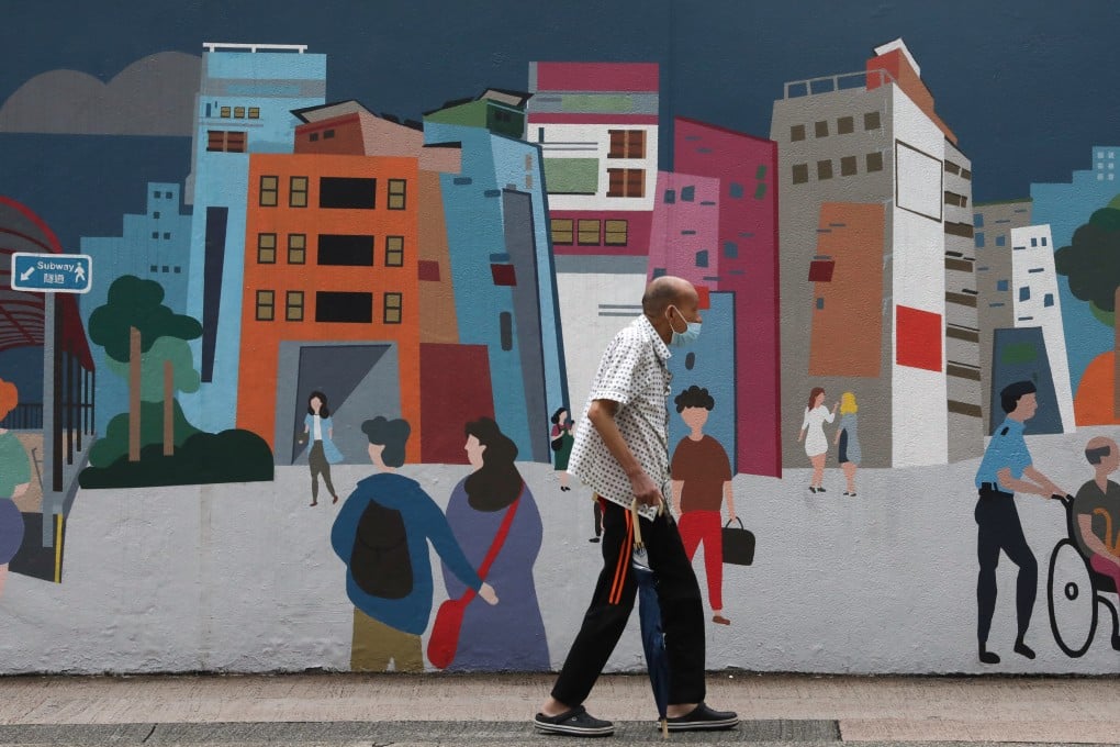 A man passes a colourful mural outside Mong Kok Police Station in Hong Kong on October 10, 2021. Photo: Jonathan Wong