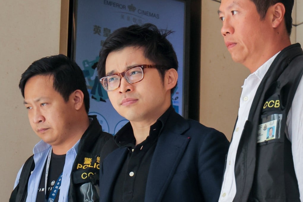 Police escort influencer Joseph Lam (centre) from his office in Central. Photo: Jelly Tse