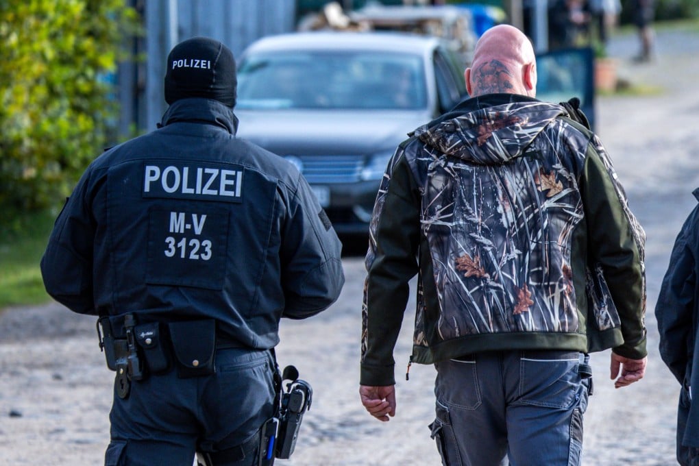 Sven Krueger, a right-wing extremist known throughout Germany, is accompanied by police during a search of his property on Tuesday. Photo: dpa