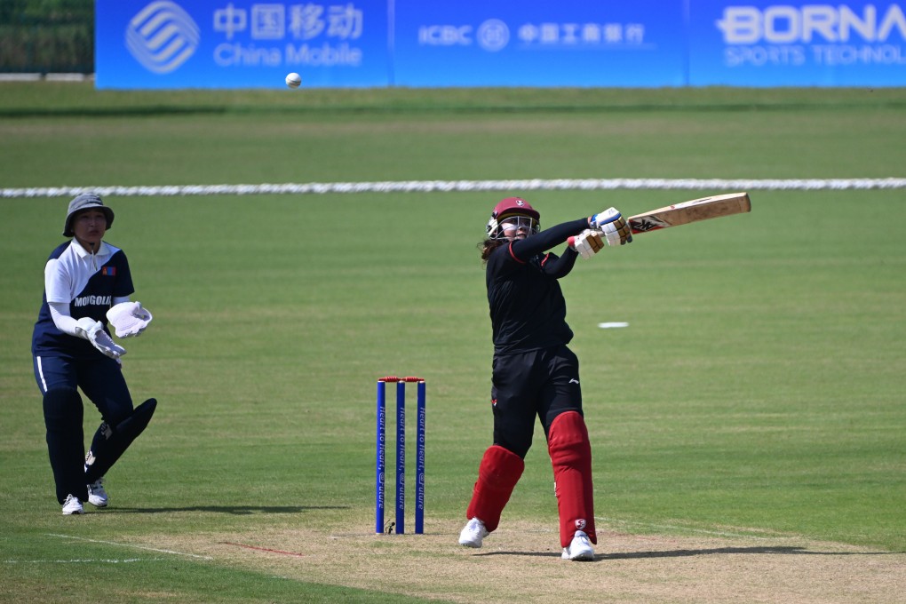 Indonesia’s Ni Luh Dewi (right) fell one run short of equalling the highest individual score in women’s Asian Games cricket in her side’s 172-run thumping of Mongolia. Photo: Xinhua
