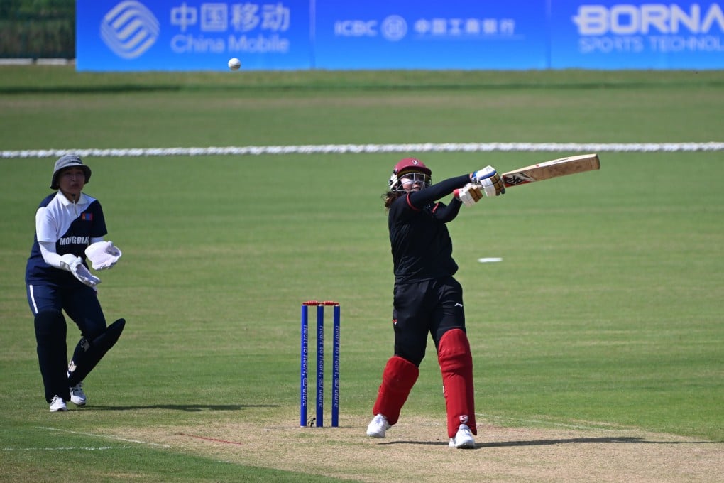 Indonesia’s Ni Luh Dewi (right) fell one run short of equalling the highest individual score in women’s Asian Games cricket in her side’s 172-run thumping of Mongolia. Photo: Xinhua