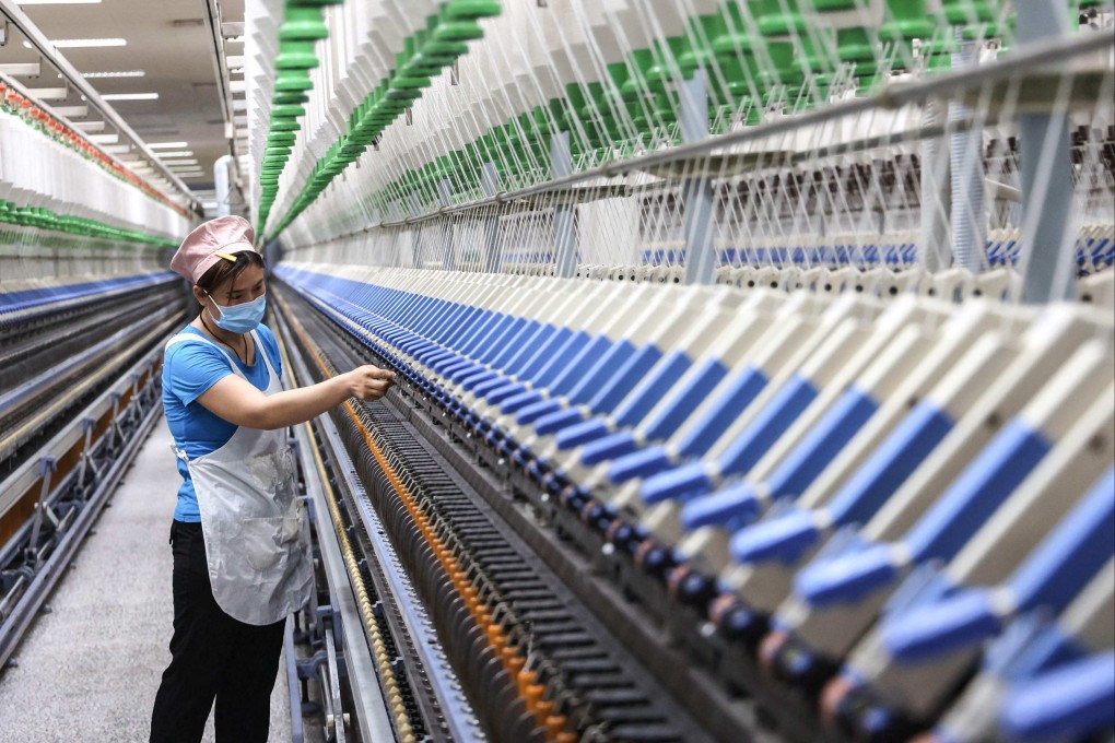 An employee works at a textile factory in Binzhou, Shandong province, on April 17. The manager of a state-owned textile supplier has expressed doubts over the likelihood of “triangular debt” being repaid en masse. Photo: AFP