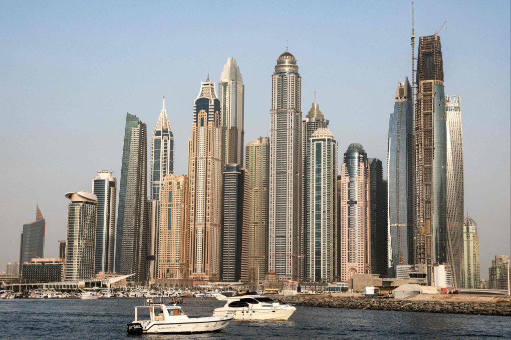 Boats moored in the gulf waters near the skyscrapers of Dubai, one of six of United Arab Emirates. Photo: AFP