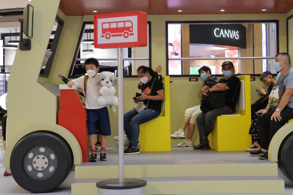 Shoppers took a breather in a simulated minibus at a shopping mall in Mong Kok on 1 August 2023. Photo: Jelly Tse