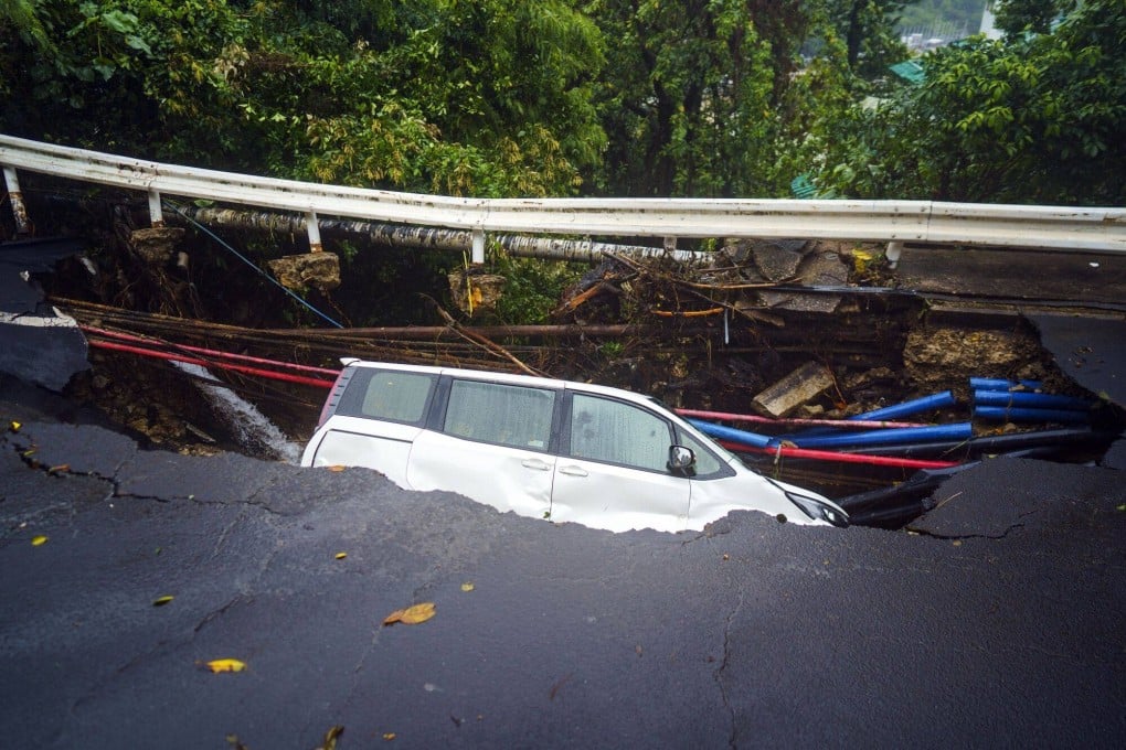 A vehicle lies in a collapsed road during heavy rain in Hong Kong, on September 8. While the city has prided itself on its good infrastructure and transport networks, extreme weather events present growing challenges. Photo: Bloomberg