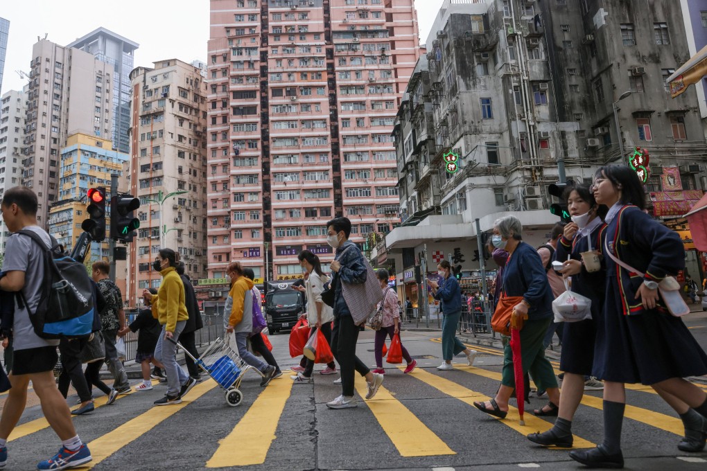 Pedestrians cross a road in Kwun Tong. Kwun Tong, which has replaced Sham Shui Po as the poorest district in the city, on April 4. Photo: May Tse