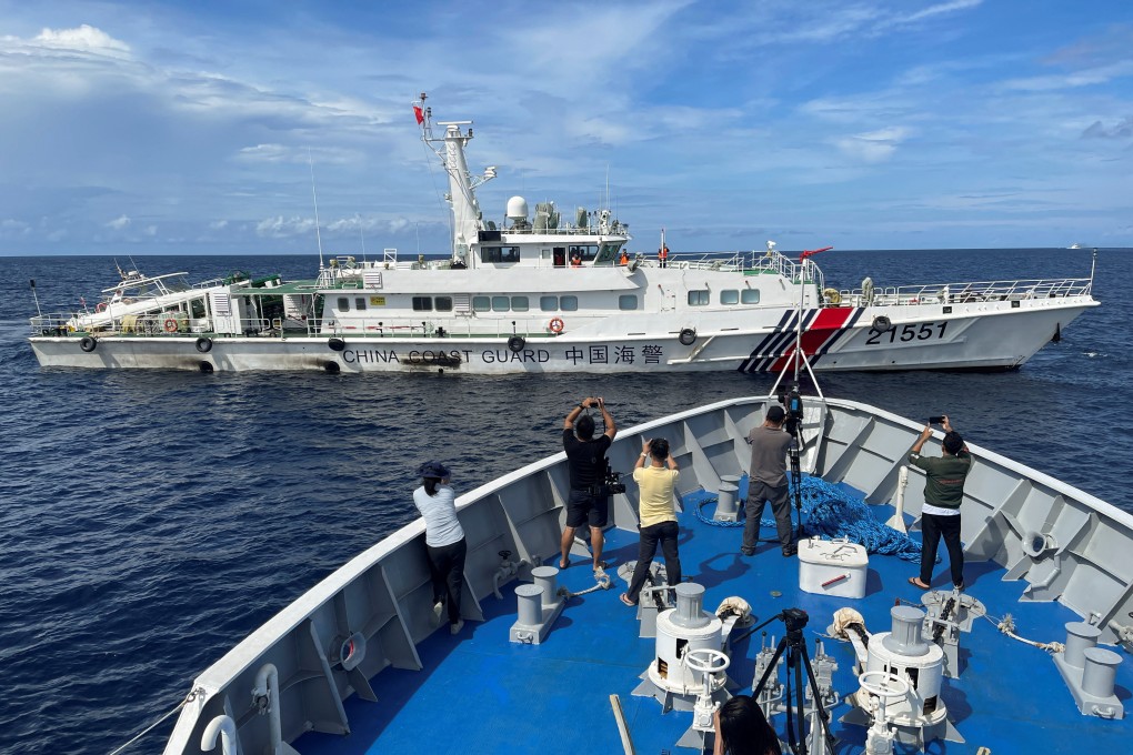 Journalists onboard a Philippines Coast Guard ship take photos of a China Coast Guard vessel. Photo: Reuters