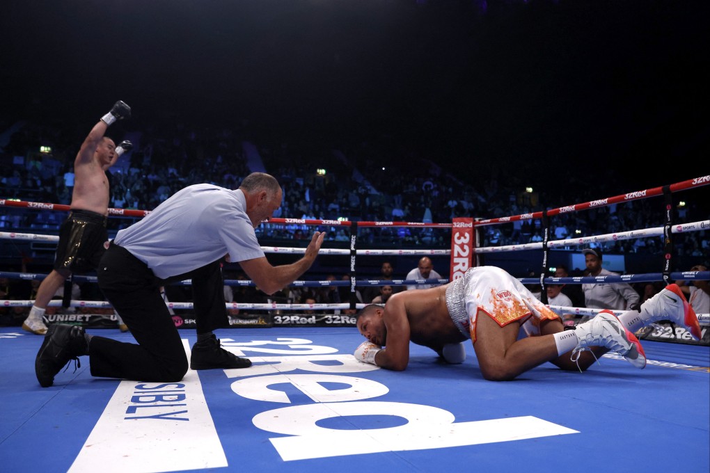 Joe Joyce is knocked down by Zhang Zhilei
in London. Photo: Action Images via Reuters
