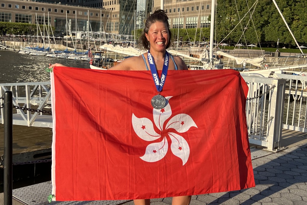 Edie Hu holds up a Hong Kong flag after swimming around Manhattan Island in the 20 Bridges challenge. Photo: Elizabeth Yuan
