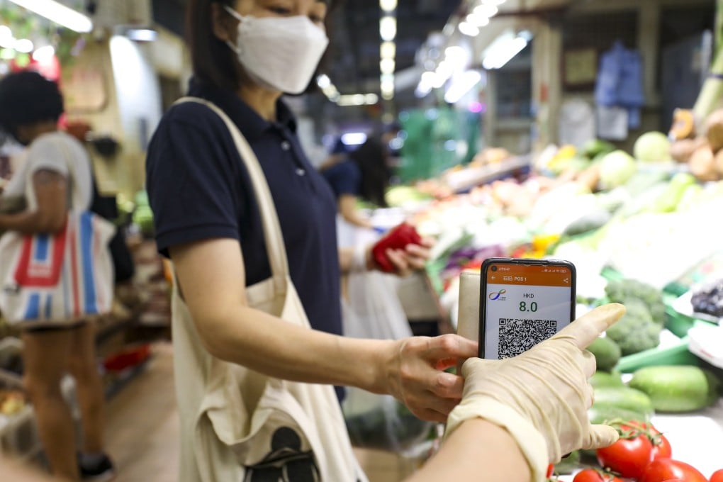 A woman swipes her Octopus car in a wet market. CEO Tim Ying has pledged to make the service more widely available in Hong Kong. Photo: Xiaomei Chen