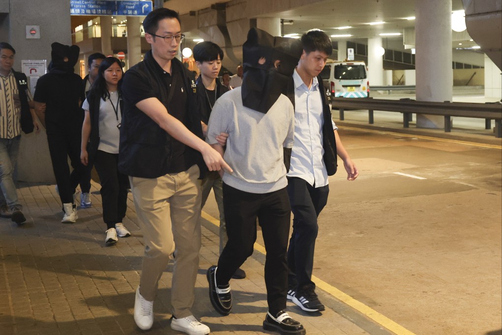 The pair arrived handcuffed and with their faces covered at the Hong Kong-Macau Ferry Terminal in Sheung Wan at around 6pm. Photo: Edmond So