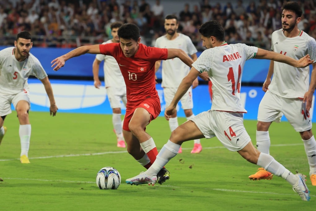 Hong Kong’s Sun Ming-him (in red) on the attack aganst iran at Shangcheng Sports Centre Stadium. Photo: Dickson Lee