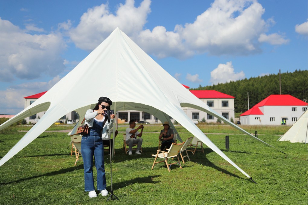 Tourists take pictures at a resort in Arxan of Hinggan League, north China’s Inner Mongolia Autonomous Region, on September 1. While Chinese tourists are having second thoughts about international travel, there has been a boom in tourism on the mainland itself. Photo: Xinhua
