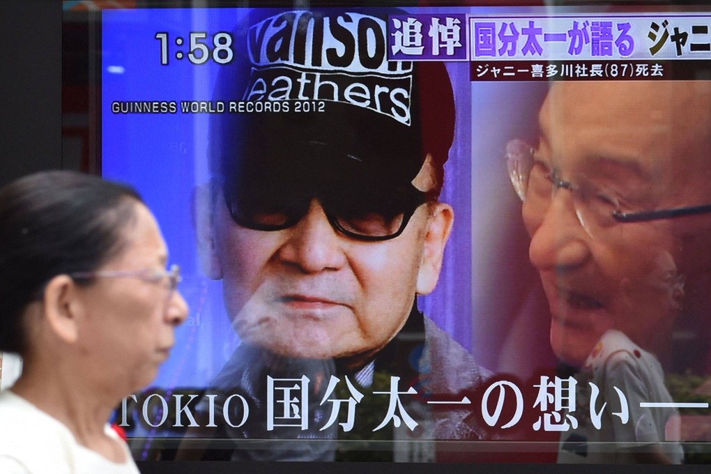 A TV screen reporting the death of Johnny Kitagawa, founder of J-pop talent agency Johnny & Associates, in Tokyo in 2019. Photo: AFP