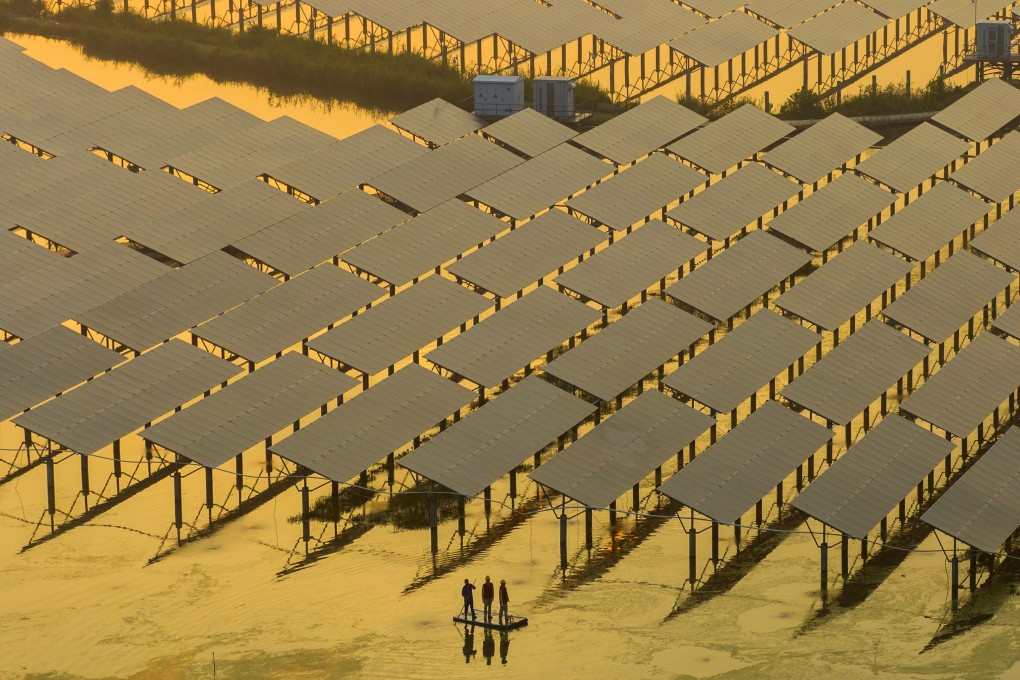 On China’s National Low Carbon Day on July 12, volunteers check on solar panels in Taizhou, Jiangsu province. Photo: CFOTO/Future Publishing via Getty Images
