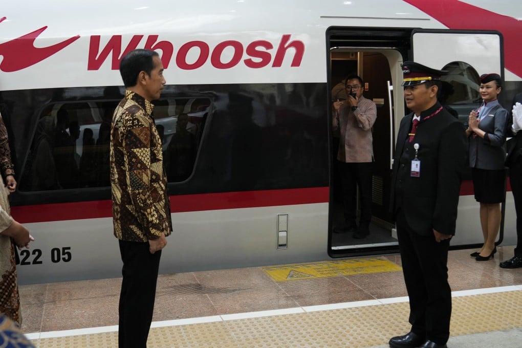 Indonesian President Joko Widodo, left, talks to officials during the launch ceremony for the Jakarta-Bandung railway at Halim station in Jakarta on Monday. Photo: AP
